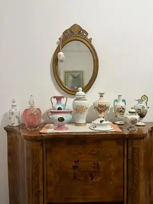 a table with vases on it with a mirror at Semini di nostalgia in Rome