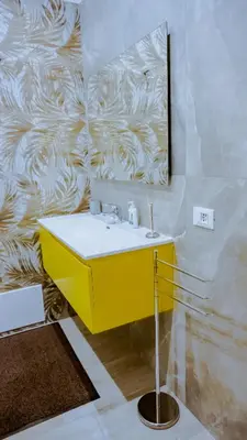 a bathroom with a yellow sink and a mirror at Charme Retreat Boki in Rome