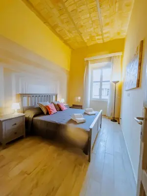 a bedroom with a large bed in a yellow room at Charme Retreat Boki in Rome