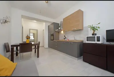 a kitchen and dining room with a table and a microwave at La Casa di Carmine in Rome