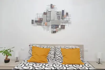 a bedroom with a bed with yellow pillows at La Casa di Carmine in Rome
