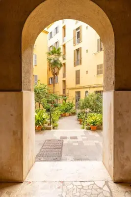 an archway leading to a courtyard with a building at San Lorenzo Residence two in Rome