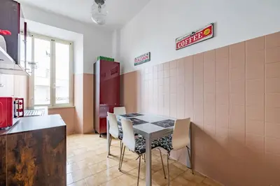 a kitchen with a table and chairs in a room at San Lorenzo Residence two in Rome