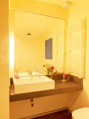 a bathroom with a sink and a large mirror at Trastevere Art House in Rome