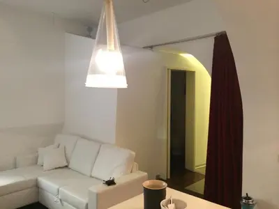 a living room with a white couch and a mirror at Trastevere Art House in Rome