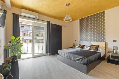 a bedroom with a bed and a large window at Charming Trastevere One in Rome