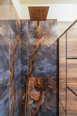 a bathroom with a fire mural on the wall at Charming Trastevere One in Rome