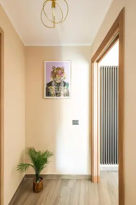 a hallway with a potted plant and a window at Charming Trastevere One in Rome