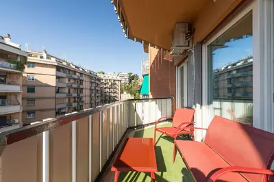 a balcony with red chairs on a building at Charming Trastevere One in Rome