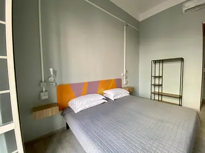 a bedroom with a bed and a mirror in it at Eureka Rooms in Rome
