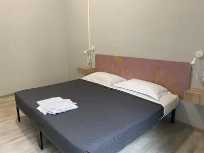 a bedroom with a bed with two towels on it at Eureka Rooms in Rome