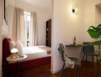 a hotel room with a bed and a table and chairs at ElevenG in Rome