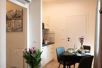 a kitchen and dining room with a table and chairs at ElevenG in Rome
