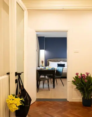 a dining room with a table and a bedroom at ElevenG in Rome