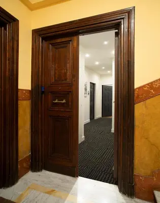 a hallway with a wooden door and a hallway with a hallway at ElevenG in Rome