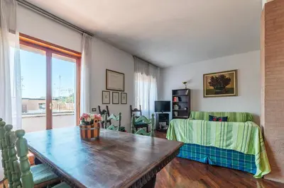 a living room with a table and a couch at GuestHost - Flaminio Apartment panoramic view with terrace in Rome
