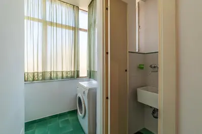 a bathroom with a toilet and a sink and a window at GuestHost - Flaminio Apartment panoramic view with terrace in Rome