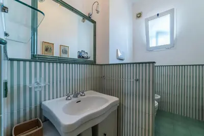a bathroom with a sink and a mirror and a toilet at GuestHost - Flaminio Apartment panoramic view with terrace in Rome