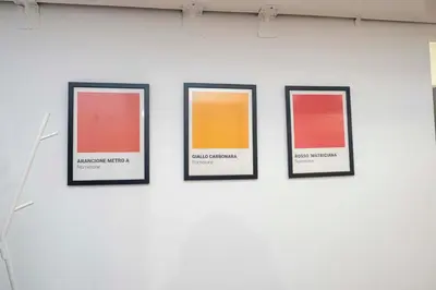 a wall with four framed pictures on a wall at La casetta ai colli - Vicino alla Metro A in Rome