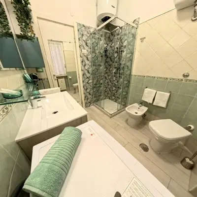 a bathroom with a shower and a sink and a toilet at La casetta ai colli - Vicino alla Metro A in Rome