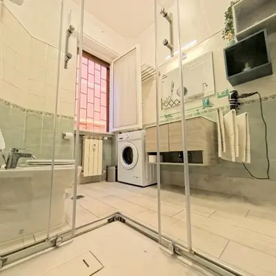 a kitchen with a washer and dryer in a room at La casetta ai colli - Vicino alla Metro A in Rome