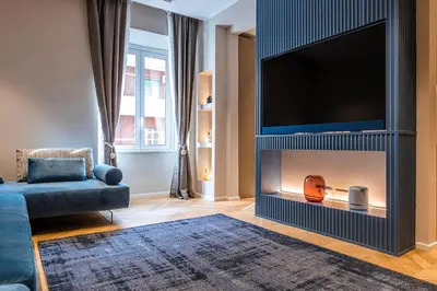 a living room with a fireplace with a flat screen tv at La Dolce Vita Luxury Apartment in Rome