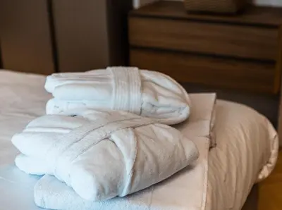 a pile of white towels sitting on top of a bed at La Dolce Vita Luxury Apartment in Rome