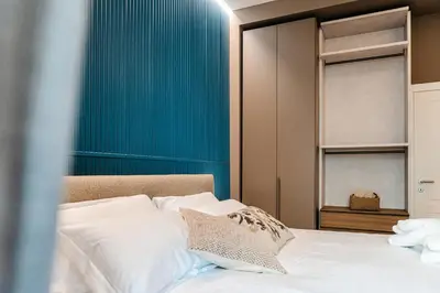 a bedroom with a bed and a blue wall at La Dolce Vita Luxury Apartment in Rome