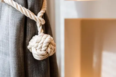 a rope knot on a curtain in a room at La Dolce Vita Luxury Apartment in Rome