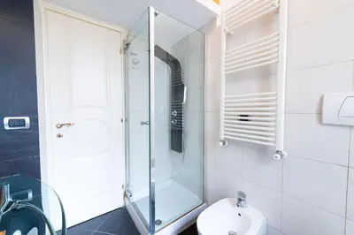 a bathroom with a glass shower and a toilet at Casa Aosta in Rome