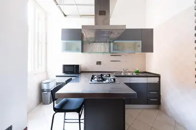a kitchen with a stove and a counter top at Casa Aosta in Rome