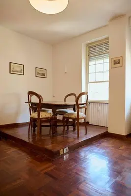 a dining room with a table and chairs and a window at Riboty 21 in Rome
