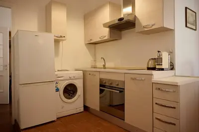 a kitchen with a white refrigerator and a dishwasher at Riboty 21 in Rome
