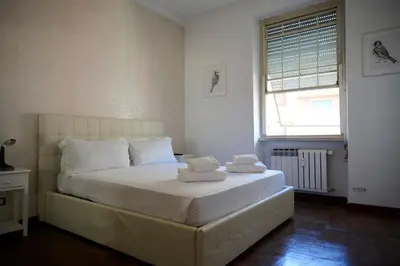 a bedroom with a bed with two towels on it at Riboty 21 in Rome