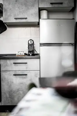 a kitchen with a refrigerator and a basket on the counter at The Little Big House in Rome