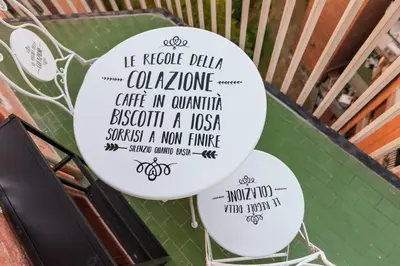 a couple of white balloons with writing on them at Charming Trastevere Two in Rome
