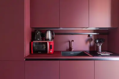 a kitchen with a red microwave and a sink at Charming Trastevere Two in Rome