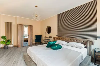 a bedroom with a large white bed with green pillows at Charming Trastevere Two in Rome