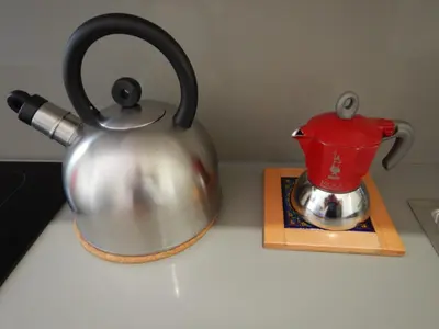 a silver tea kettle sitting on top of a counter at Barberini Bright Apartment in Rome
