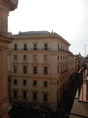 a large white building with a lot of windows at Barberini Bright Apartment in Rome