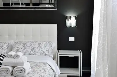 a bedroom with a bed with towels on it at Black & White G&G in Rome