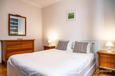 a bedroom with a white bed and two night stands at Mecenate Apartment Fori Imperiali in Rome