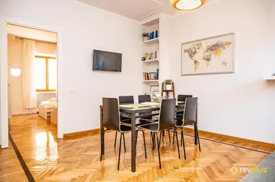 a dining room with a table and chairs at Mecenate Apartment Fori Imperiali in Rome