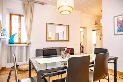 a dining room with a table and chairs at Mecenate Apartment Fori Imperiali in Rome