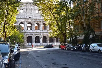 a city street with cars parked in front of a building at Vinylogy Apartment 5to Piano in Rome