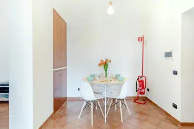 a kitchen and dining room with a table and chairs at Vinylogy Apartment 5to Piano in Rome