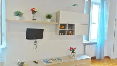 a room with a desk with a tv on a wall at Casa Tua a Monti in Rome