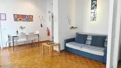 a living room with a couch and a table at Casa Tua a Monti in Rome