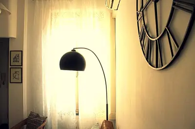 a lamp in a room with a window and a mirror at Apartment - Laterano 85 in Rome
