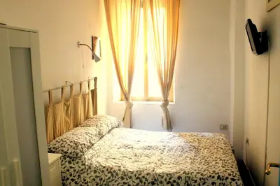 a bedroom with a bed and a window at Apartment - Laterano 85 in Rome